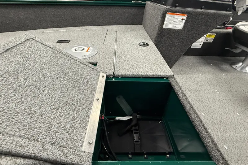 Slide: The Image of 2026 Lund Angler 1650 SS boat interior with open storage compartment. - 14