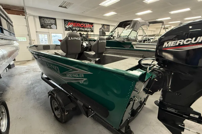 Slide: The Image of 2026 Lund Angler 1650 SS boat with Mercury engine in showroom. - 17