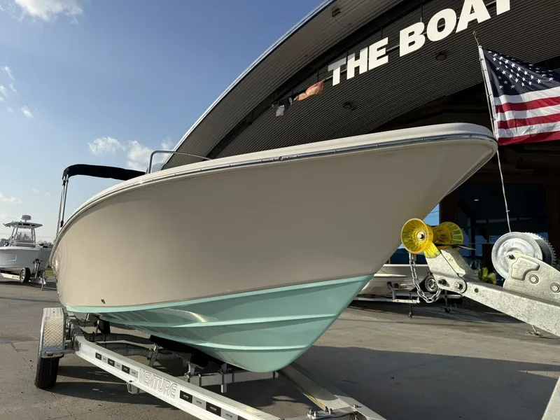 Slide: The Image of 2026 Sea Chaser 23 LX boat on trailer outside store. - 3