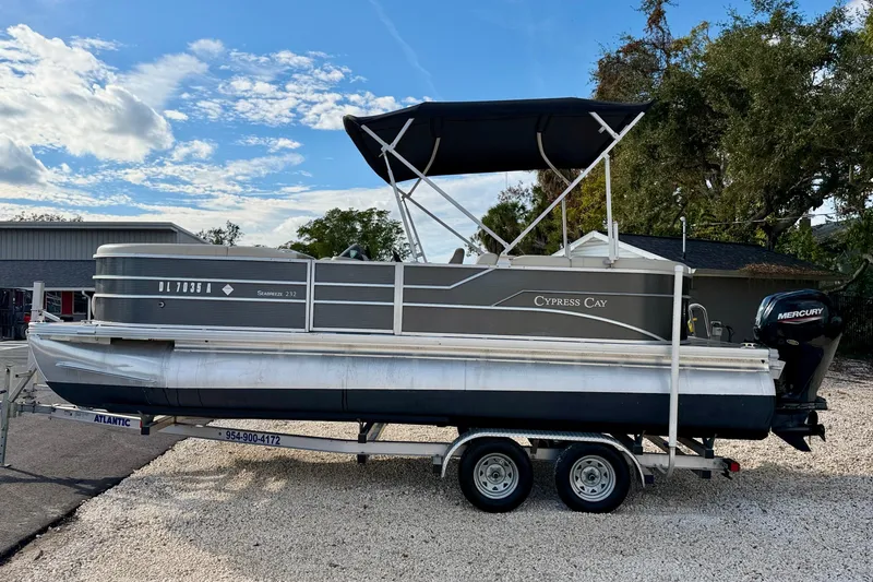 The Image of 2022 Cypress Cay Seabreeze 232 pontoon boat on trailer, parked outdoors. - 0