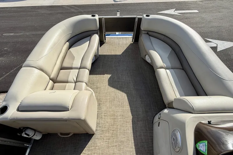 Slide: The Image of 2022 Cypress Cay Seabreeze 232 boat seating with beige upholstery and cup holder. - 11