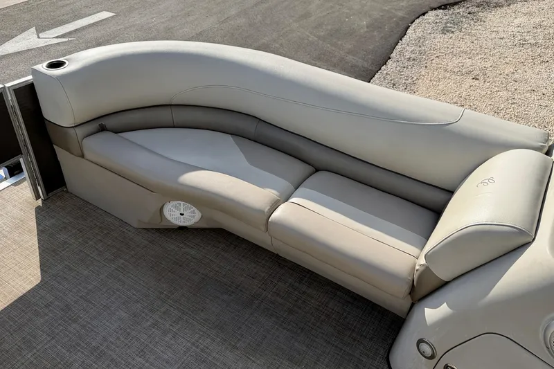 Slide: The Image of Interior of 2022 Cypress Cay Seabreeze 232 pontoon boat with beige seating and steering console. - 12