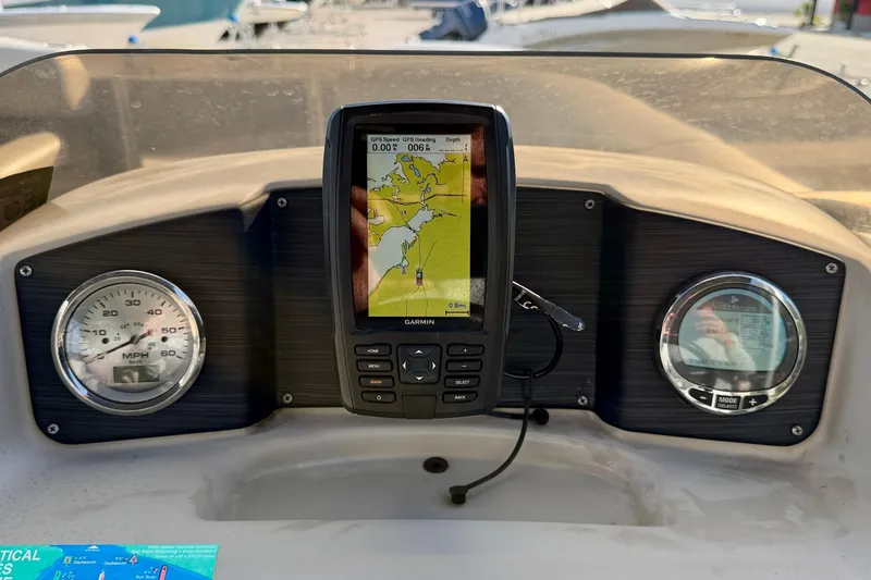 Slide: The Image of 2022 Cypress Cay Seabreeze 232 boat seating with beige upholstery and cup holders. - 21