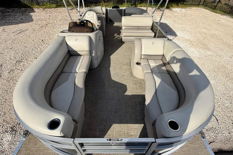 Slide: The Image of 2022 Cypress Cay Seabreeze 232 pontoon boat interior with beige seating and carpet flooring. - 9