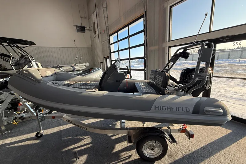 The Image of 2026 Highfield Sport 390 boat displayed indoors on a trailer. - 0