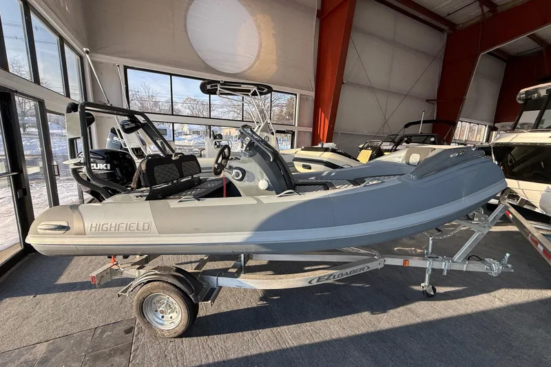 Slide: The Image of 2026 Highfield Sport 390 boat on trailer in showroom. - 2