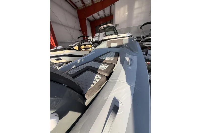 Slide: The Image of 2026 Highfield Sport 390 boat interior in a showroom, featuring sleek design and seating. - 4