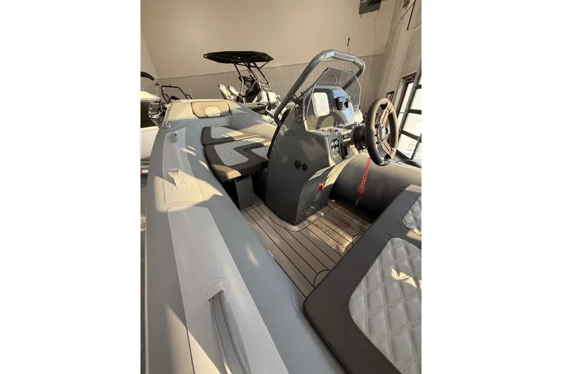 Slide: The Image of 2026 Highfield Sport 390 boat interior with modern steering console and seating. - 5