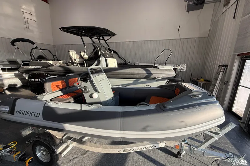 The Image of 2026 Highfield Sport 360 inflatable boat on trailer in showroom. - 4