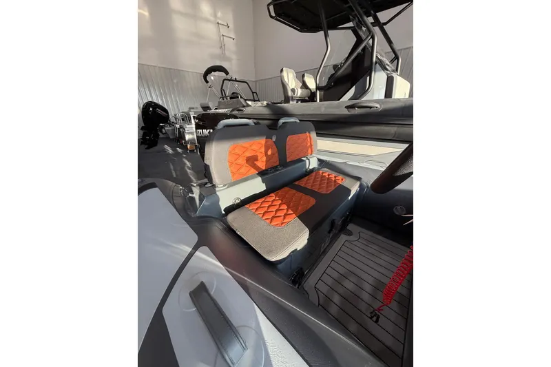 Slide: The Image of 2026 Highfield Sport 360 boat interior with orange quilted seats and modern design. - 6