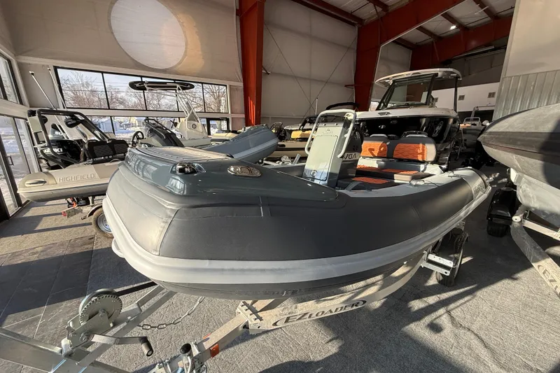 Slide: The Image of 2026 Highfield Sport 360 boat displayed in a showroom, featuring sleek design and modern features. - 9