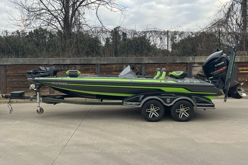 The Image of 2016 Skeeter FX20 Limited Edition boat with green accents on a trailer. - 0