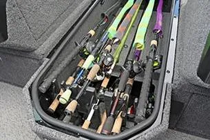 Slide: The Image of 2026 Lund 1875 Pro-V boat interior with carpeted deck and storage compartments. - 10