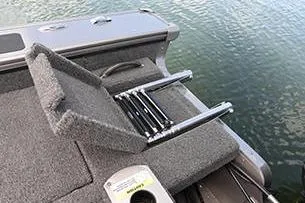 Slide: The Image of 2026 Lund 1875 Pro-V boat interior with gray seating and storage compartments. - 11