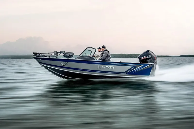 Slide: The Image of 2026 Lund 1875 Pro-V boat interior with seating and steering console. - 13