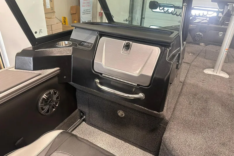 Slide: The Image of Interior of 2026 Lund 1875 Pro-V boat, featuring storage and speaker. - 18
