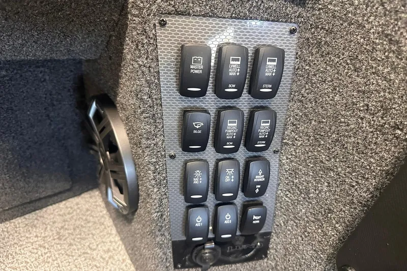 Slide: The Image of Control panel of 2026 Lund 1875 Pro-V boat with various switches. - 21