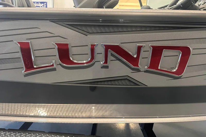 Slide: The Image of 2026 Lund 1875 Pro-V boat logo with sleek design and metallic finish. - 23