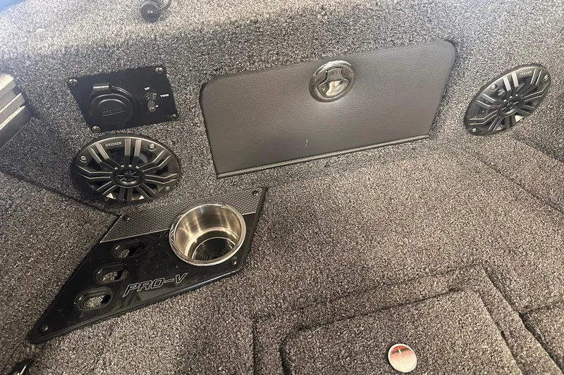 Slide: The Image of Interior of 2026 Lund 1875 Pro-V boat with speakers and cup holder. - 24