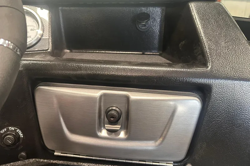 Slide: The Image of Dashboard of 2026 Lund 1875 Pro-V boat with storage compartment and ignition switch. - 25