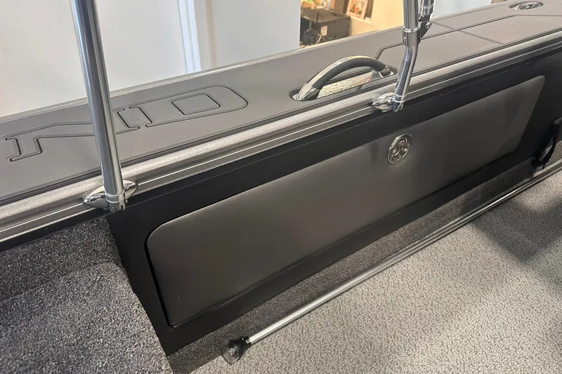 Slide: The Image of 2026 Lund 1875 Pro-V boat interior with storage compartment and sleek design. - 26