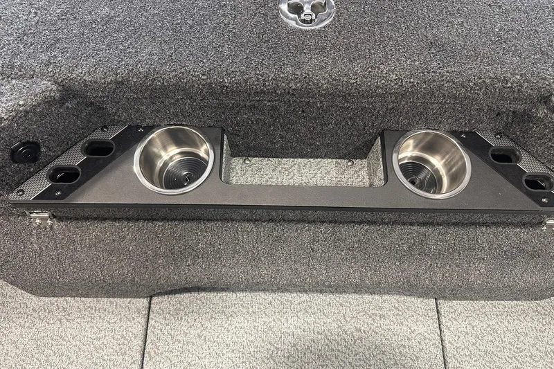 Slide: The Image of 2026 Lund 1875 Pro-V boat interior with cup holders and carpeted finish. - 31