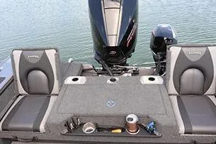 Slide: The Image of 2026 Lund 1875 Pro-V boat interior with steering console and seating. - 7