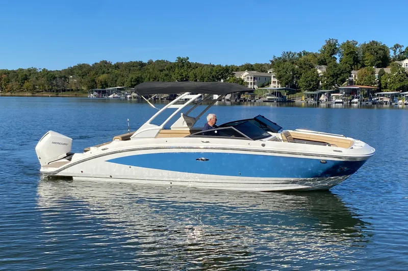 The Image of 2022 Sea Ray SDX 270 Outboard boat on a calm lake with scenic background. - 1