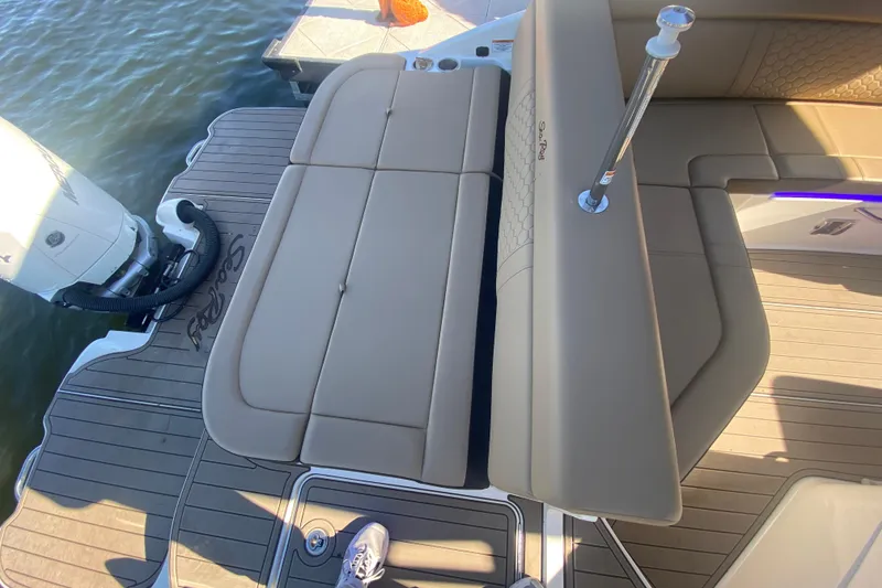 Slide: The Image of 2022 Sea Ray SDX 270 Outboard boat with tan seating and deck, docked by water. - 10