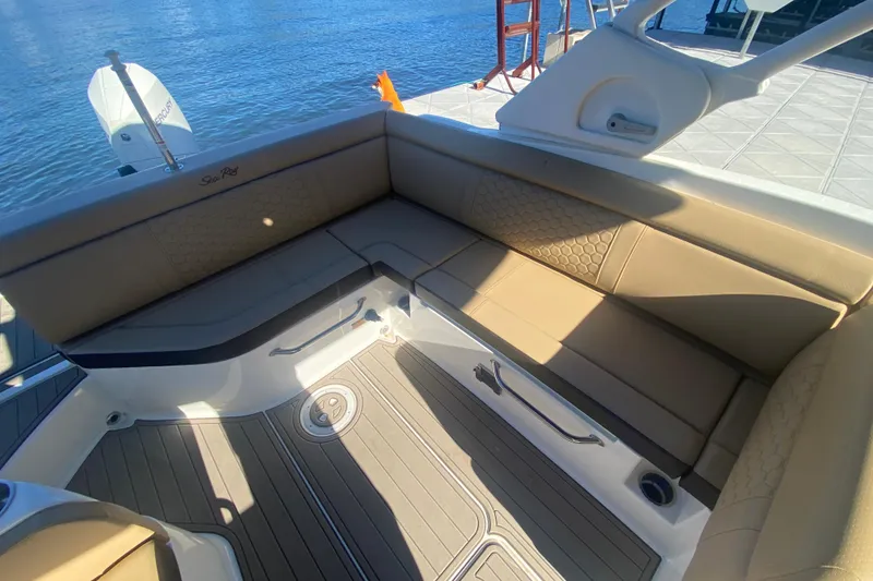 Slide: The Image of 2022 Sea Ray SDX 270 Outboard boat interior with tan seating and water view. - 13