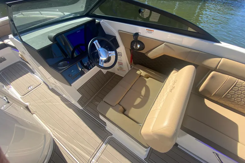 Slide: The Image of 2022 Sea Ray SDX 270 Outboard boat interior with beige seating and modern dashboard. - 16