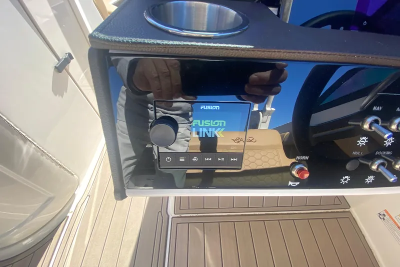 Slide: The Image of 2022 Sea Ray SDX 270 Outboard dashboard with Fusion Link audio system. - 17