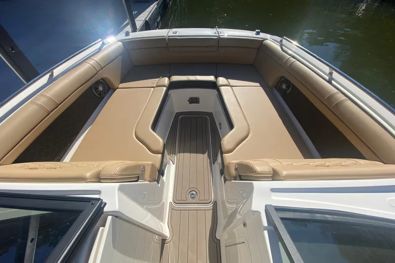 Slide: The Image of 2022 Sea Ray SDX 270 Outboard boat interior with tan seating and spacious layout. - 24