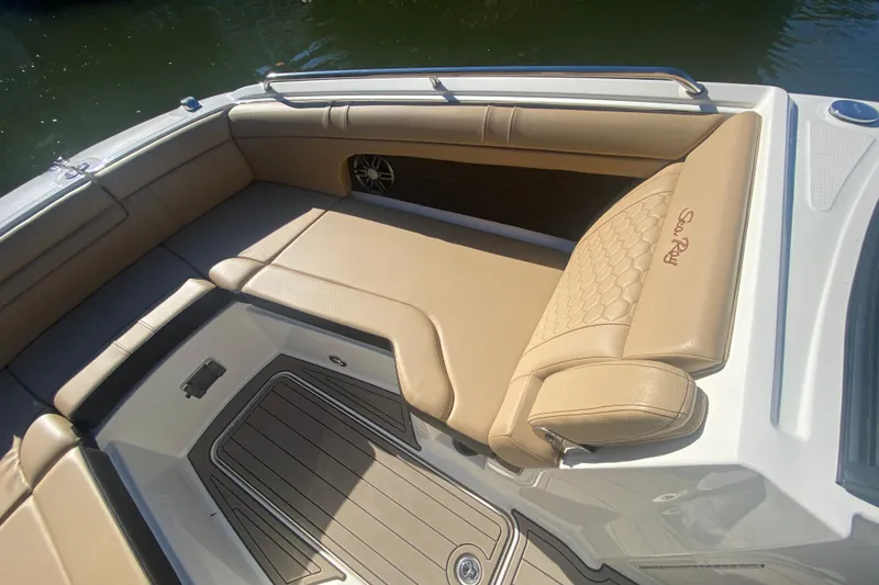 Slide: The Image of 2022 Sea Ray SDX 270 Outboard boat interior with tan seating and speaker. - 26