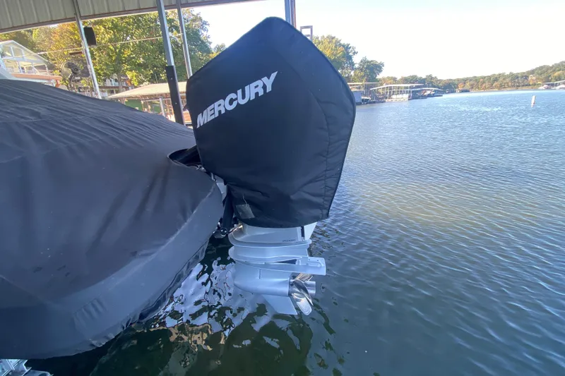 Slide: The Image of 2022 Sea Ray SDX 270 Outboard with Mercury engine cover, docked on a calm lake. - 35