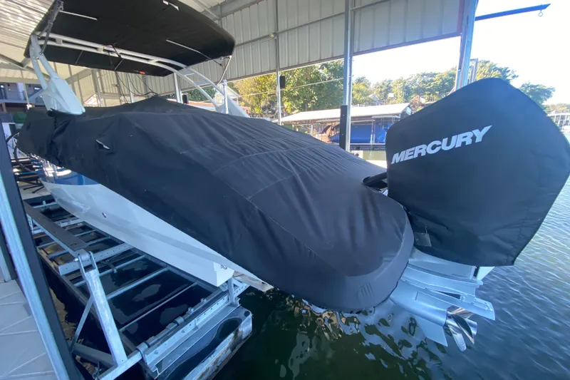 Slide: The Image of 2022 Sea Ray SDX 270 Outboard boat covered, docked with Mercury engine. - 36