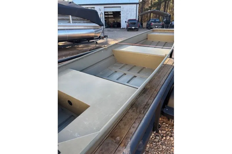 Slide: The Image of 2024 Tracker Grizzly 1436 Jon boat interior, showcasing seating and storage areas. - 4