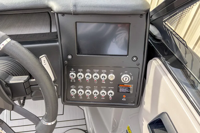 Slide: The Image of 2024 Moomba Max boat dashboard with control panel and steering wheel. - 10