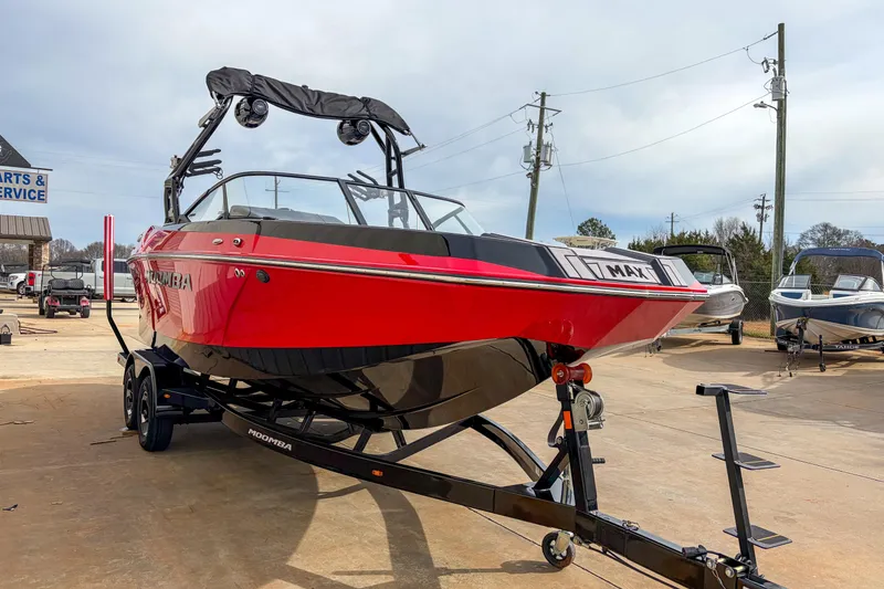 Slide: The Image of 2024 Moomba Max boat in vibrant red on trailer at dealership. - 3