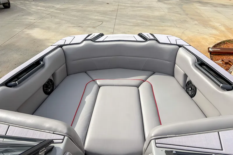 Slide: The Image of 2024 Moomba Max boat interior with gray seating and red accents. - 4