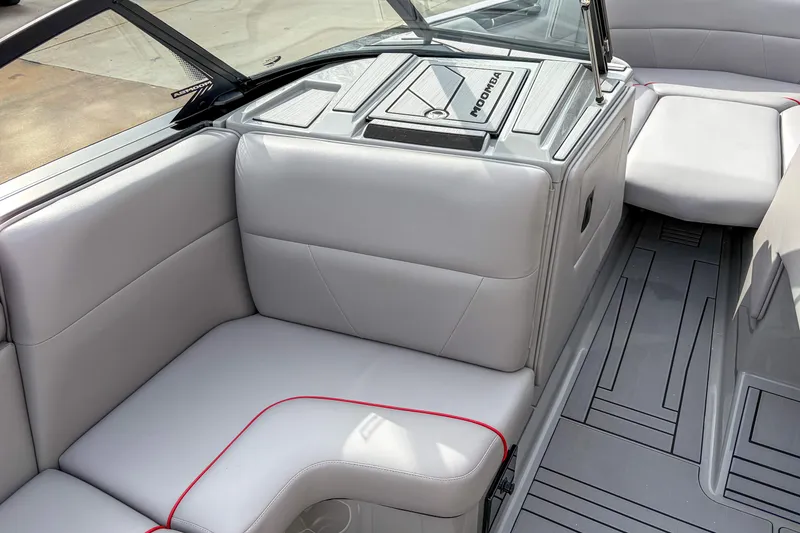 Slide: The Image of 2024 Moomba Max boat interior with gray seating and red accents. - 5