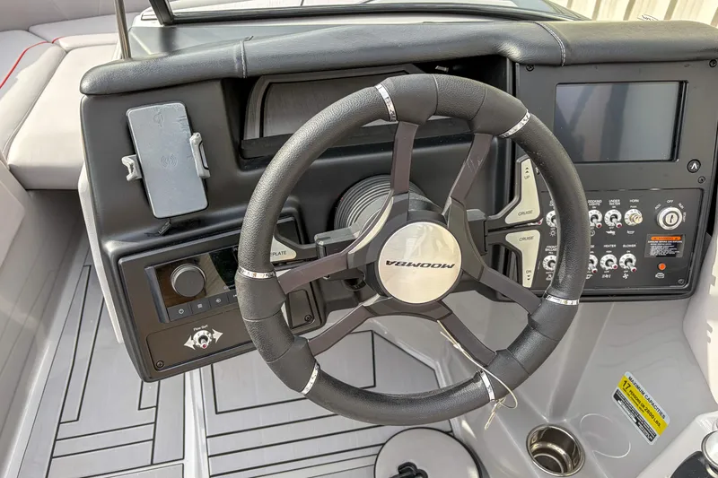 Slide: The Image of 2024 Moomba Max boat dashboard with steering wheel and control panel. - 9