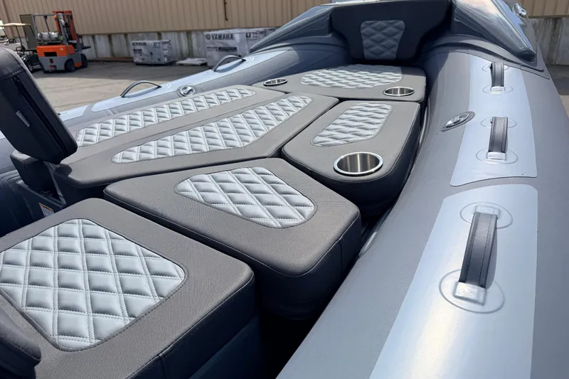 Slide: The Image of 2026 Highfield Sport 520 boat interior with quilted seating and cup holders. - 13