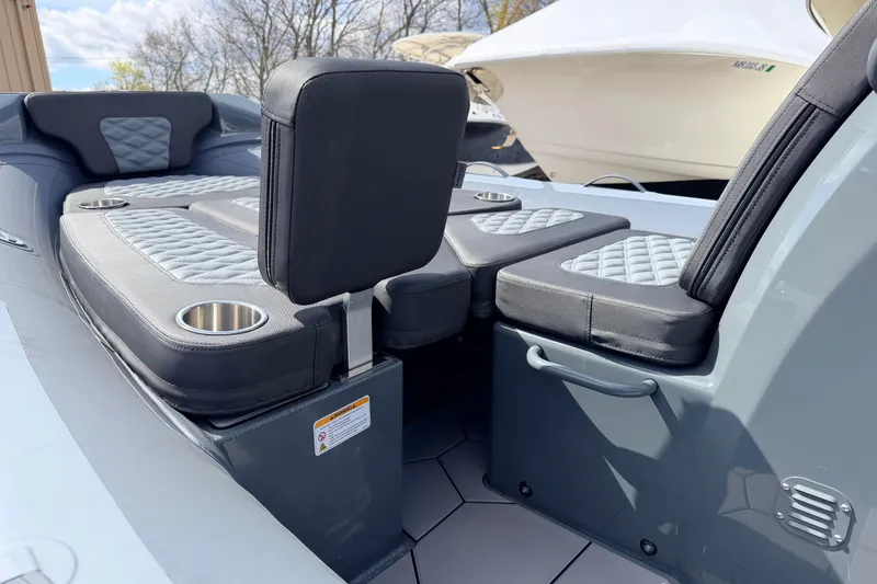 Slide: The Image of Interior seating of 2026 Highfield Sport 520 boat with quilted cushions and cup holders. - 14