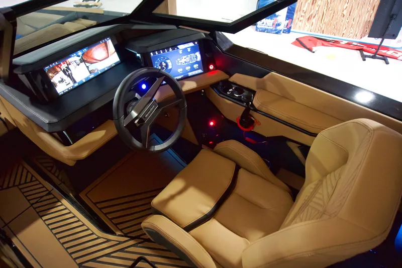 Slide: The Image of 2025 MasterCraft XStar 23 boat interior with advanced dashboard and luxurious seating. - 10