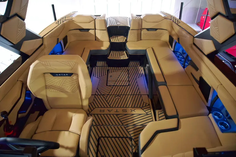 Slide: The Image of 2025 MasterCraft XStar 23 interior with luxurious tan seating and modern design. - 13