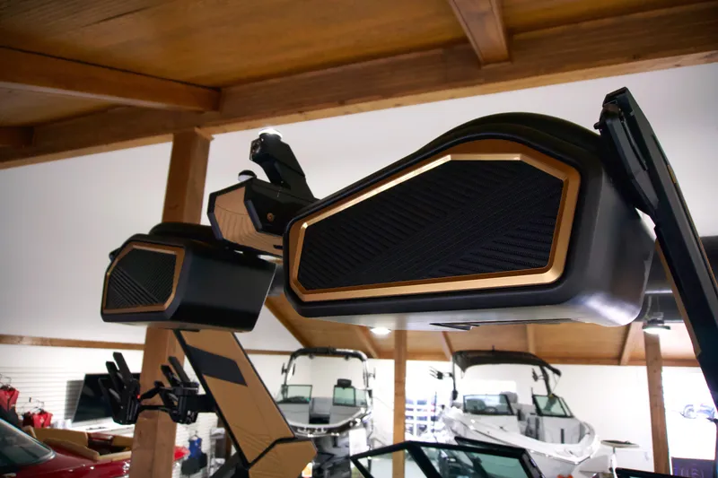 Slide: The Image of 2025 MasterCraft XStar 23 boat speakers in showroom, showcasing sleek design and advanced audio features. - 15