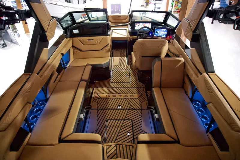 Slide: The Image of Luxurious interior of 2025 MasterCraft XStar 23 boat with tan seating and modern dashboard. - 5