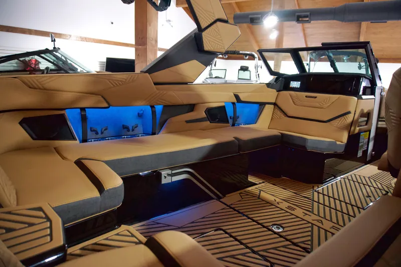 Slide: The Image of Luxurious interior of 2025 MasterCraft XStar 23 boat with tan seating and blue lighting. - 6