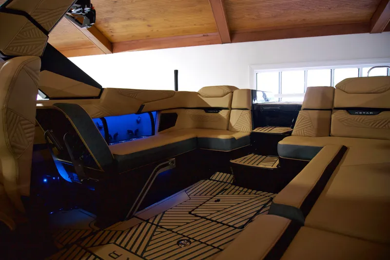 Slide: The Image of Luxurious interior of 2025 MasterCraft XStar 23 boat with tan seating and ambient lighting. - 7